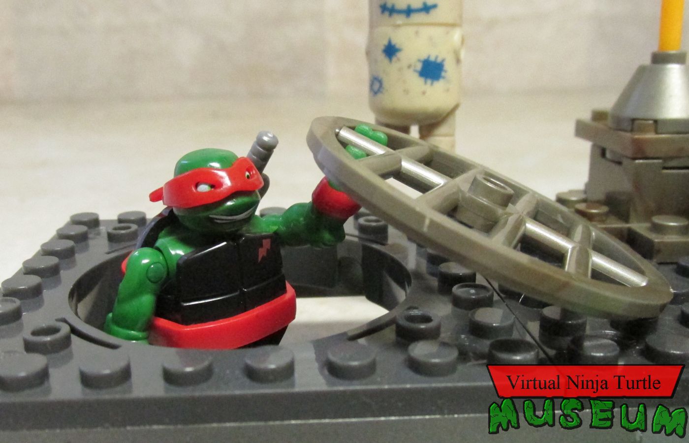 Raph coming out of sewer grate