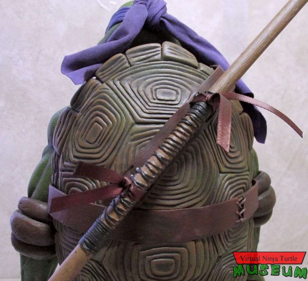 staff stored on his back
